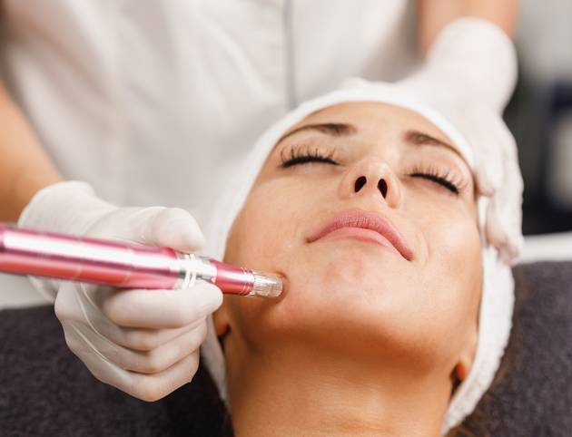 Shot of a beautiful young woman on a facial dermapen micro-needling treatment at the beauty salon.